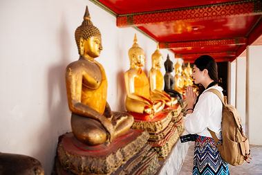 attractive-friendly-female-student-standing-front-buddha-making-pray-gesture-wishing-healt
