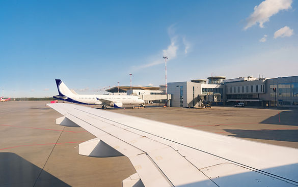 busy-airport-view-with-airplanes-against-clear-sky.jpg